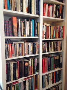 We had shelves built. When the size of the books allow, we double up. (I would say this picture represents about 10% of our books.)